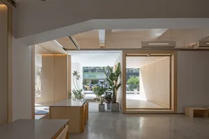 A minimalist commercial interior featuring wood materials and open spaces.