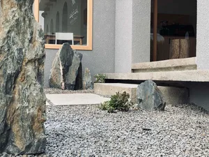 Modern lobby featuring concrete, gravel, and green plants