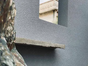 A close-up of a modern architectural detail featuring concrete construction materials.