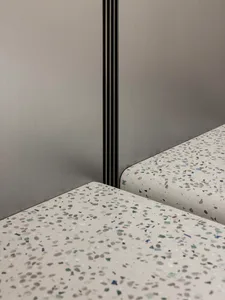 Modern interior design featuring a display of terrazzo floor tiles.