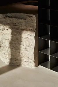 Concrete wall with natural lighting and shadow details, highlighting minimalist architectural design.