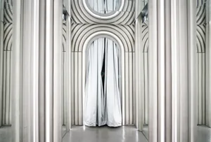 A minimalist interior design featuring a white curtain with arched arches and reflective surfaces.
