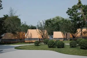 Modern wooden homes with triangular roofs and window accents surrounded by greenery and pathways.