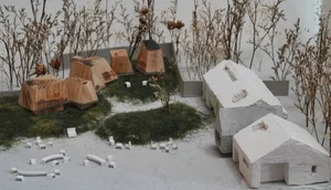 A modern architectural model featuring concrete and wooden structures.
