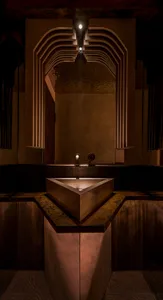 Modern bathroom with concrete walls and art deco lighting