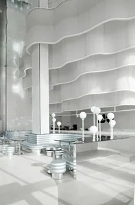 A modern coffee shop featuring a metallic counter with a sleek, minimalist design.
