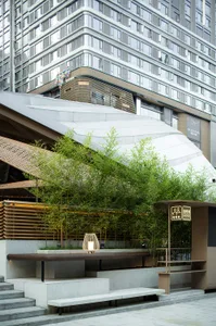 A modern, architectural design featuring concrete and wood materials with a sleek, streamlined appearance.