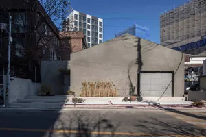 A modern storefront with a concrete and glass exterior.