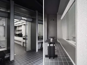 A modern industrial coffee shop with concrete flooring.