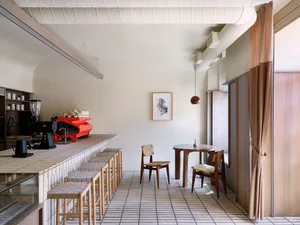 A modern minimalist coffee shop featuring sleek design elements and a black and white color palette.