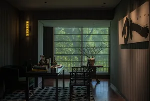 A modern, minimalist office space with wooden furniture, glass elements, and metal accents.