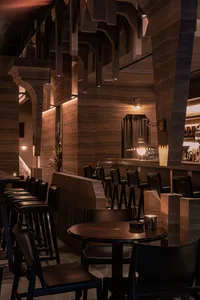 Industrial design cafe bar with stone walls, leather seating, and metal accents