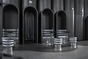 A modern industrial seating area with metallic furniture