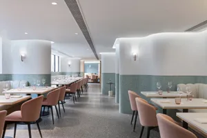 A minimalist restaurant interior featuring terrazzo accents and modern design elements.