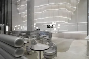 A modern minimalist restaurant featuring contemporary design elements and futuristic lighting.