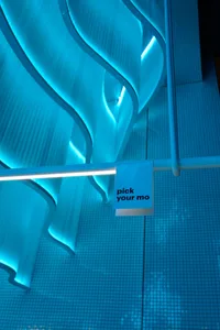 Modern interior with curved glass paneling and blue lighting