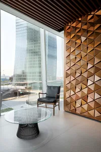 Modern office space featuring glass, concrete, and wooden textures.