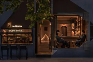 A cozy, modern restaurant bar with wooden finishes and a warm, inviting atmosphere.