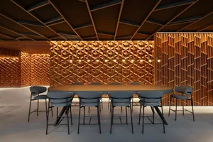 Modern office space featuring geometric wood panels and contemporary furniture.