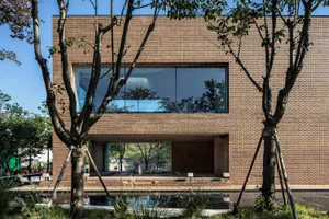 Modern house with brick exterior and large windows.