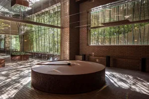 A modern spa interior with brick and concrete materials and large windows.
