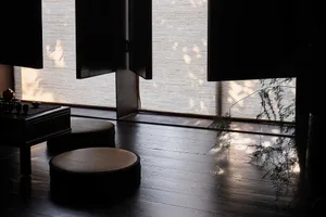 A serene bamboo-blinds-living-room with natural lighting and minimalist interior design.