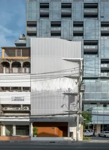 Modern building exterior featuring a combination of concrete and metal materials.