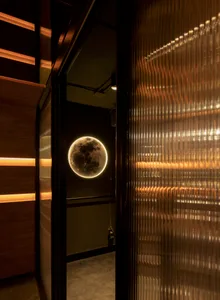 Modern restaurant and bar interior featuring a glass window with a illuminated moon