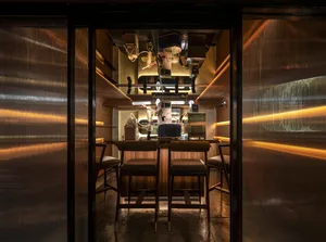 Industrial themed cafe bar interior with metal, wood, and glass materials.