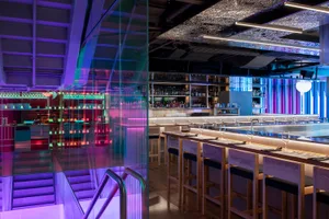 Modern restaurant bar interior with glass walls and seating