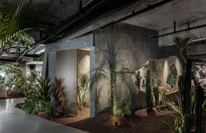 Industrial retail space featuring a conveyor belt system and concrete design elements