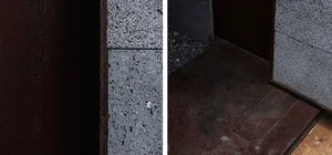 Close-up view of rustic concrete fireplace interior.