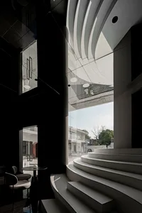A modern interior space featuring concrete materials and steps.