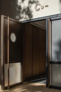 A wooden door with metal accents in an industrial storefront setting.