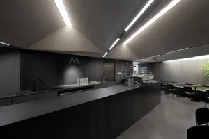 A modern, minimalist coffee shop with a sleek concrete counter and industrial lighting.