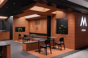 Modern cafe interior featuring concrete and wood materials.