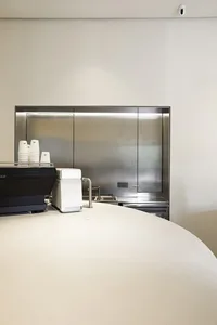 Modern coffee shop counter with metallic finish.