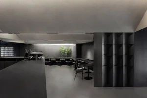 Interior view of a modern restaurant featuring minimalist design with concrete finishes.