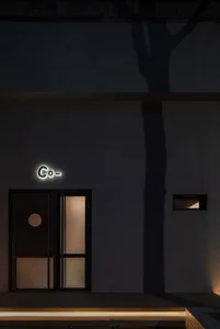 A modern retail storefront with glass frontage and a concrete base.