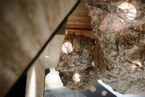 Crinkled paper light installation hanging from the ceiling.