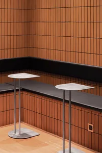 A modern coffee shop with a metal and concrete counter.