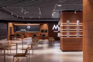 Contemporary coffee shop featuring modern design elements of wood and concrete.