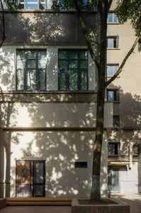 A modern architectural interior featuring a concrete facade and large windows.