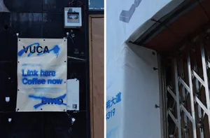 Urban design showing a scaffolding setup around a building corner with a poster featuring the word 'Vuca'.