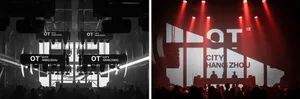Auditorium with bright white stage lights and red lights on stage and ceiling, with silhouetted performers.