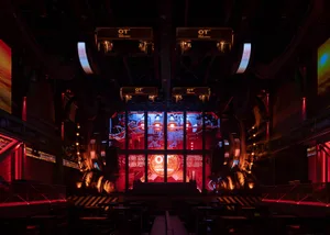 An industrial-style stage with metallic elements and lighting.