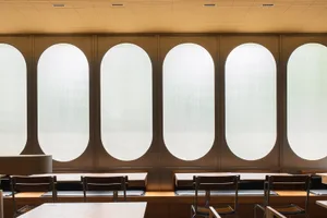 A modern classroom featuring oval-shaped windows made of frosted glass.