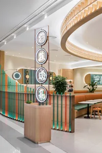 A modern dining room with wooden accents and colorful lighting.