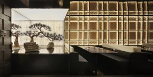 Modern restaurant interior with metallic wall panels and seating areas