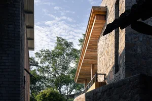 An exterior of a building with stucco and wooden features.